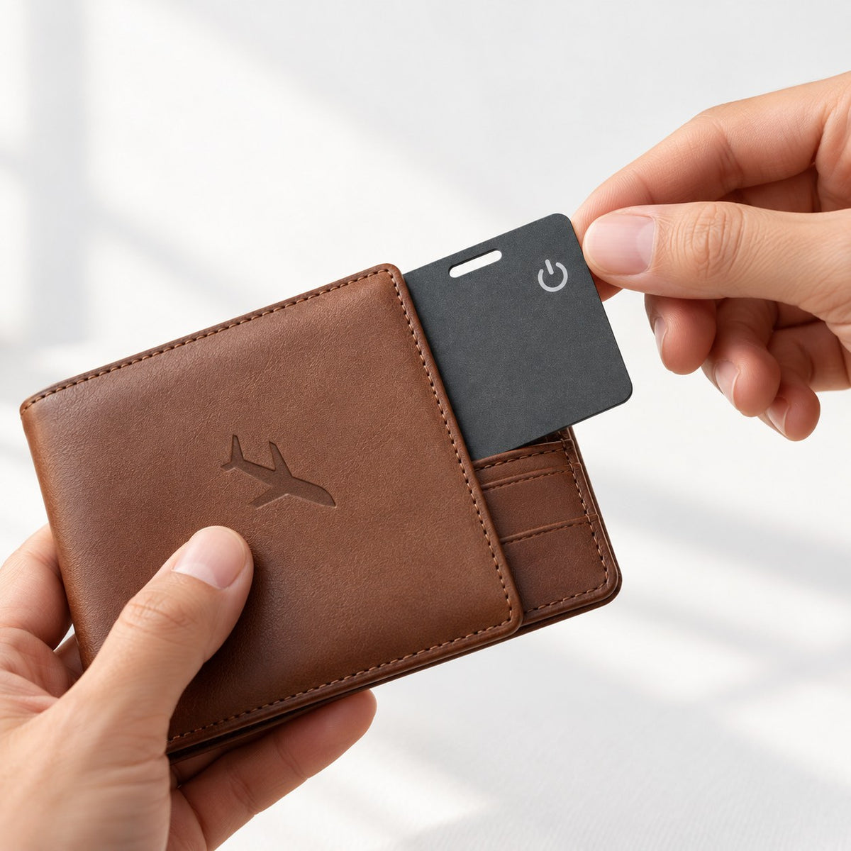 Slimfind tracker card sliding into a leather wallet card slot